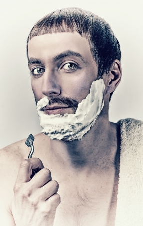 Portrait of a man shaving in vintage styleの写真素材