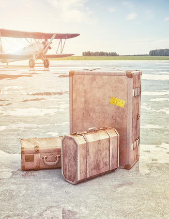 Vintage suitcases and retro airplane on runway. 3d conceptの写真素材