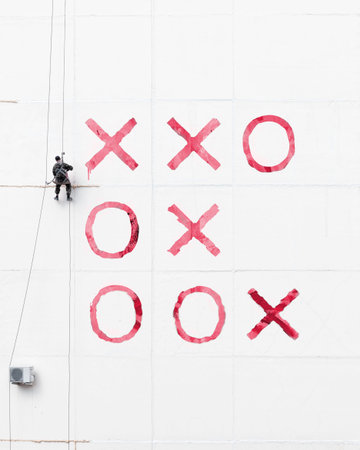 Maintenance worker play tick-tack-toe  outside a wall