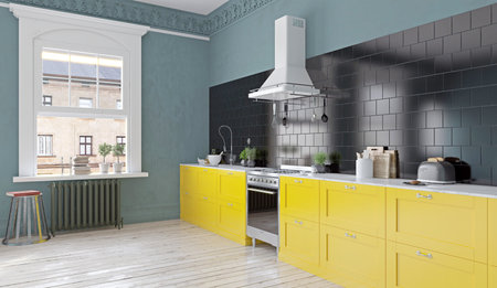 Modern kitchen with yellow cabinets and black backsplash.の写真素材