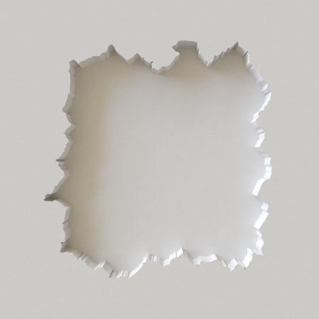 Irregular black hole in white wall with jagged edges.の写真素材