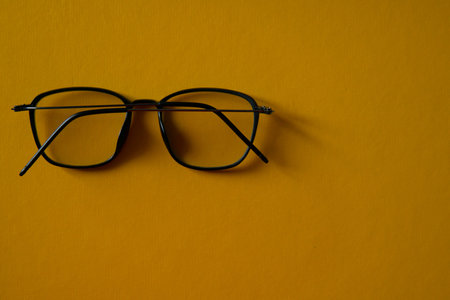 black sunglasses on yellow background negative spaceの写真素材