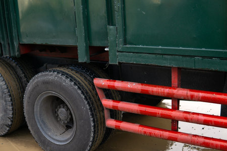 Close-up of the wheel of a truck covered with a red barrier