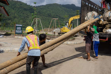Unidentified workers are building a new road.の写真素材
