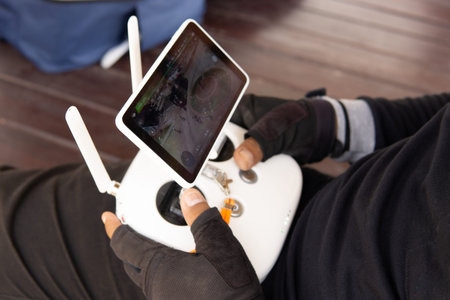 Drone quadcopter in the hands of a man with a tablet.