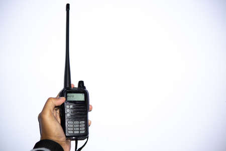 Hand holding walkie talkie on a white background with copy spaceの写真素材