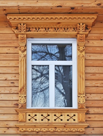Carving decorated window in new country wooden house, Russiaの写真素材