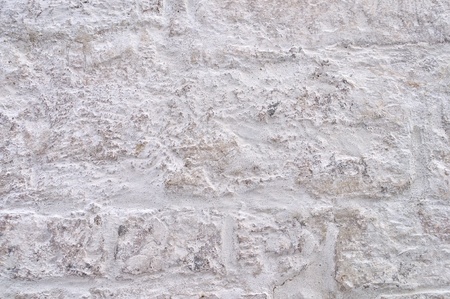 Fragment of white rough brick wall surface backgroundの写真素材