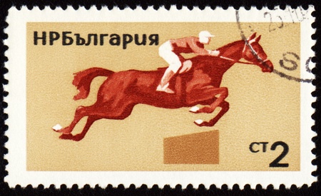 BULGARIA - CIRCA 1965: stamp printed in Bulgaria, shows equestrian sport, triathlon, circa 1965の写真素材