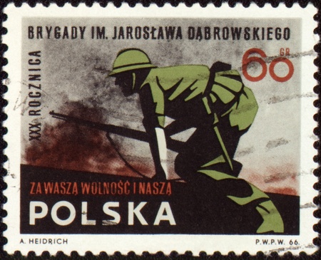 POLAND - CIRCA 1966: A post stamp printed in Poland shows soldiers in the attack, devoted to the XXX anniversary of the brigade Jaroslaw Dabrowski, circa 1966の写真素材