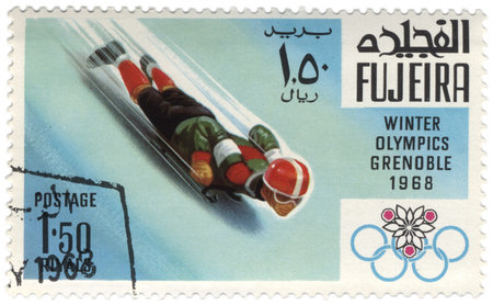Fujeira - CIRCA 1968  A stamp printed in Fujeira shows downhill on a sled, devoted to the Winter...