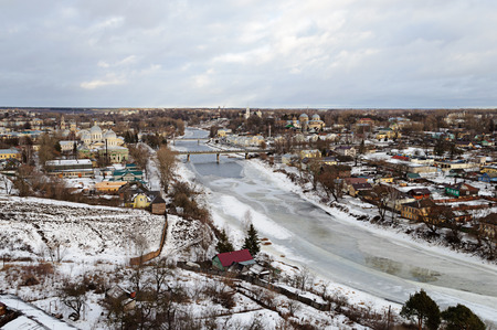 Top view of the ancient Russian town Torzhok in winter with snow-covered buildings and frozen river Tvertsaの写真素材