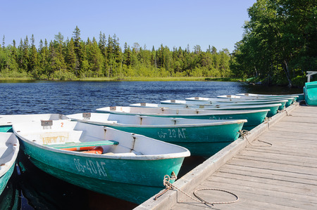 SOLOVKI, RUSSIA - JULY 21, 2015: Pleasure boats at the pier to the boat station, sunny summer dayの写真素材