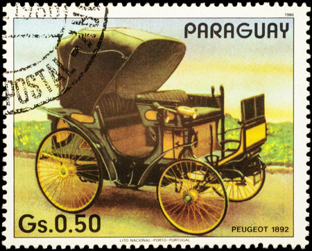 MOSCOW, RUSSIA - FEBRUARY 18, 2016: A stamp printed in Paraguay shows old car Peugeot (1892), series "The 100th Anniversary of Automobiles", circa 1986のeditorial素材