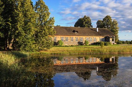 Manor house and pond at sunset, village Trigorskoye, Pushkinskiye Gory Reserve, Russiaのeditorial素材
