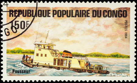MOSCOW, RUSSIA - AUGUST 05, 2016: A stamp printed in Congo shows image of pusher ship, series "Transport - Ships", circa 1984のeditorial素材