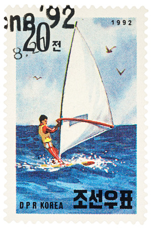 MOSCOW, RUSSIA - NOVEMBER 21, 2016: A stamp printed in DPRK (North Korea) shows windsurfer in the sea, series "International Stamp Exhibition Riccione '92 - Riccione, Italy - Sailboats", circa 1992のeditorial素材