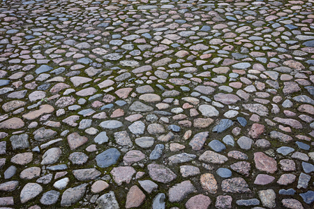 Fragment of old cobblestone pavement surfaceの写真素材