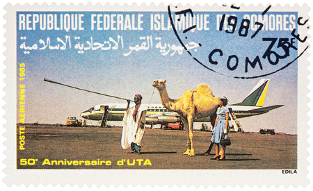 MOSCOW, RUSSIA - January 21, 2017: A stamp printed in Comoros shows passenger aircraft DC-9, arab with camel and stewardess, series "The 50th Anniversary of Union des Transports Aeriennes", circa 1985のeditorial素材