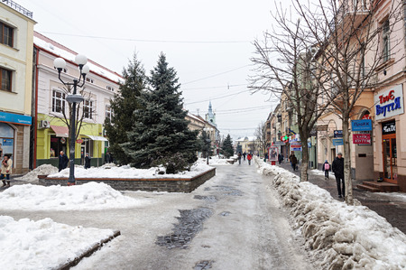 Mukachevo, Ukraine - January 31, 2017: Dukhnovicha street in center of Mukachevo. Dirty snow on a roadside, nasty winter day.のeditorial素材