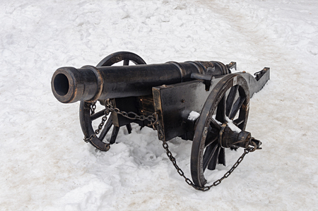 Ancient cannon in castle Palanok of Mukachevo, Ukraine. Winter time, white snow background.のeditorial素材