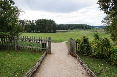 View of the meadow and forest from the manor of Mikhailovskoye village, Pushkinskiye Gory, Pskov region, Russiaのeditorial素材