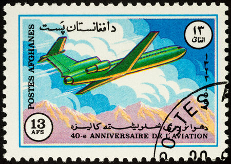 Moscow, Russia - April 14, 2017: A stamp printed in Afghanistan shows flying passenger airliner over mountains, series "40th Anniversary of the ICAO - International Civil Aviation Organization", circa 1984のeditorial素材