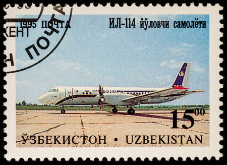 Moscow, Russia - July 05, 2017: A stamp printed in Uzbekistan shows airliner Ilyushin IL-114, series "Aircraft of Tashkent's Aircraft Factory", circa 1995のeditorial素材