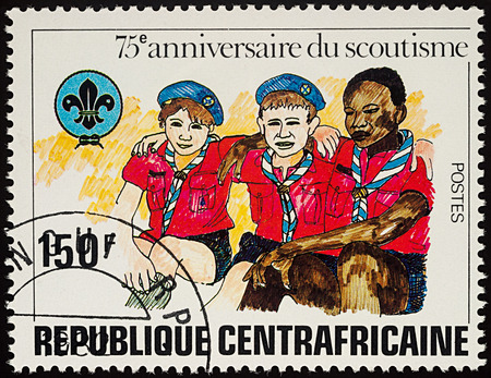 Moscow, Russia - August 04, 2017: A stamp printed in Central African Republic shows three Boy Scouts, series "The 75th Anniversary of Boy Scout Movement", circa 1982のeditorial素材