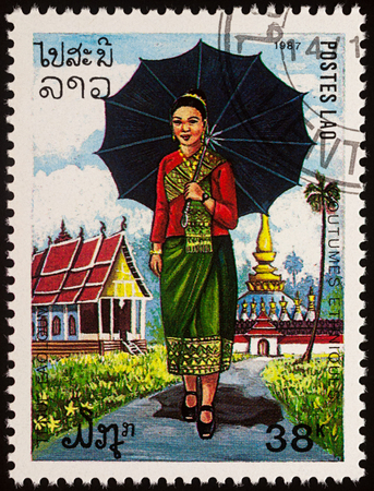 Moscow, Russia - August 06, 2017: A stamp printed in Laos, shows a woman in the national language Buddhist temple, seriesのeditorial素材