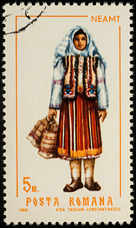Moscow, Russia - August 08, 2017: A stamp printed in Romania, shows young woman in Romanian national costume, Neamt county, series "Folk costumes", circa 1968のeditorial素材