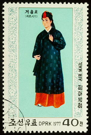 Moscow, Russia - August 09, 2017: A stamp printed in DPRK (North Korea), shows a woman in traditional Korean costume for winter, series "National Costumes", circa 1977のeditorial素材