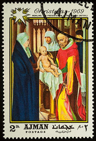 Moscow, Russia - August 20, 2017: A stamp printed in Ajman, shows painting "Presentation in the Temple" (detail) by Hans Memling (1433-1494), series "Christmas - Paintings", circa 1969のeditorial素材