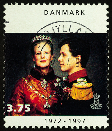 Moscow, Russia - November 03, 2017: A stamp printed in Denmark shows portrait of Danish Queen Margrethe II with Crown Prince Frederik, series "Queen Margrethe II", circa 1997のeditorial素材