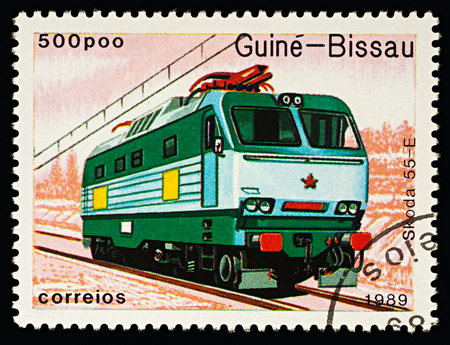 Moscow, Russia - February 14, 2018: A stamp printed in Guinea Bissau, shows electric locomotive Skoda 55E (Czechoslovakia, 1973-1975), series "Trains", circa 1989のeditorial素材