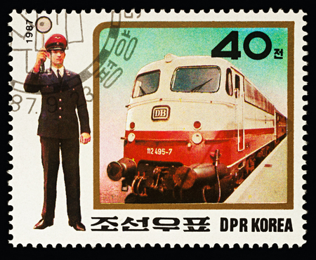 Moscow, Russia - February 16, 2018: A stamp printed in DPRK (North Korea), shows Express Train and traffic controller , series "Uniforms of railway staff", circa 1987のeditorial素材