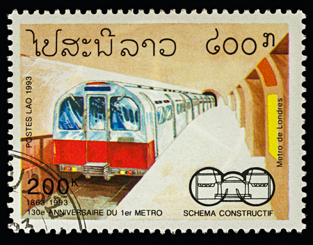 Moscow, Russia - February 18, 2018: A stamp printed in Laos, shows Metro station and train in London, series "The 130th Anniversary of Underground Railway Systems", circa 1993のeditorial素材