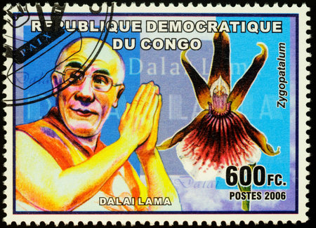 Moscow, Russia - November 27, 2019: Stamp printed in Congo, shows portrait of Dalai Lama and flower...