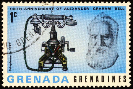 Moscow, Russia - March 02, 2020: stamp printed in Grenada, shows Alexander Graham Bell (1847-1922), American inventor, scientist, engineer, and his telephone in 1895, circa 1977のeditorial素材