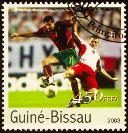 Moscow, Russia - September 21, 2020: stamp printed in Guinea-Bissau shows two football players fight for the ball, series European Football Championship 2004, Portugal, circa 2003のeditorial素材