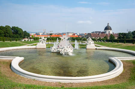 Vienna, Austria - July 30, 2019: Fountain in Belvedere Garden, Lower palace in the distanceのeditorial素材