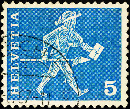 Moscow, Russia - January 29, 2021: stamp printed in Switzerland shows Messenger of Freiburg (17th century), series Postal History - Motifs and Monuments, circa 1960のeditorial素材