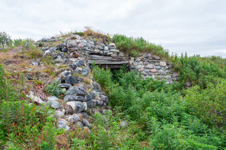 Remains of an old abandoned stone pillbox from the second world war. Sredniy Peninsula, Murmansk region, Northern Russiaの写真素材