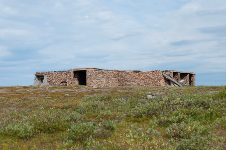 Remains of old abandoned stone structures in tundra. Rybachy Peninsula, Murmansk region, Northern Russiaの写真素材