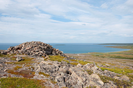 Old abandoned military stone pillbox on the shore of the Barents Sea. Rybachy Peninsula, Murmansk...