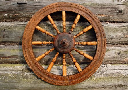 Hand spinning wheel on the wall of the old log house in the Russian village. の写真素材