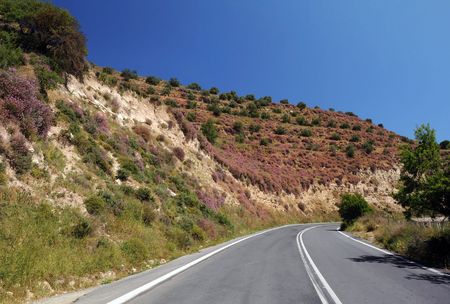 Empty motor-road and the hills covered with heather on Crete island in Greeceの写真素材