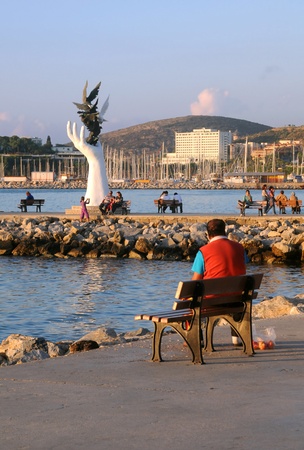 KUSADASI, TURKEY - OCTOBER 4: People relaxing in the port of Kusadasi at sunset October 4, 2009 in Kusadasi, Turkey のeditorial素材