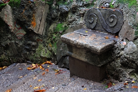 Lone stone bench on a dull day after rain in the fallの写真素材