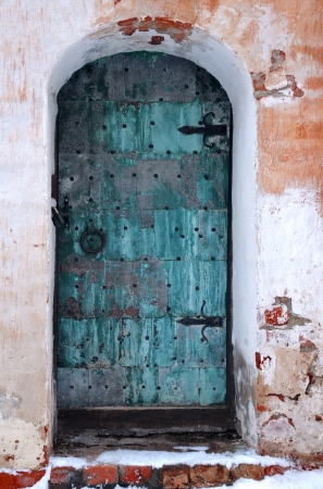 Old shabby entrance to one of the buildings in the medieval convent in Russiaの写真素材